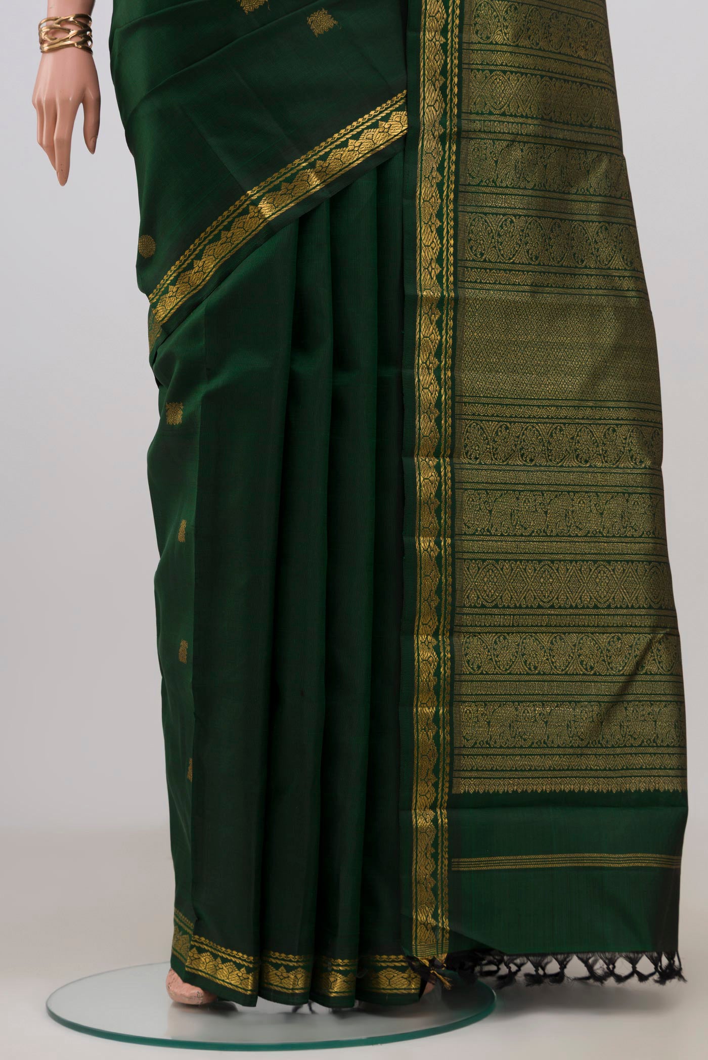 Pleats and pallu of Pure Silk Pure Zari Green Kanchipuram Saree with Zari Butta on the body and Zari Border. 