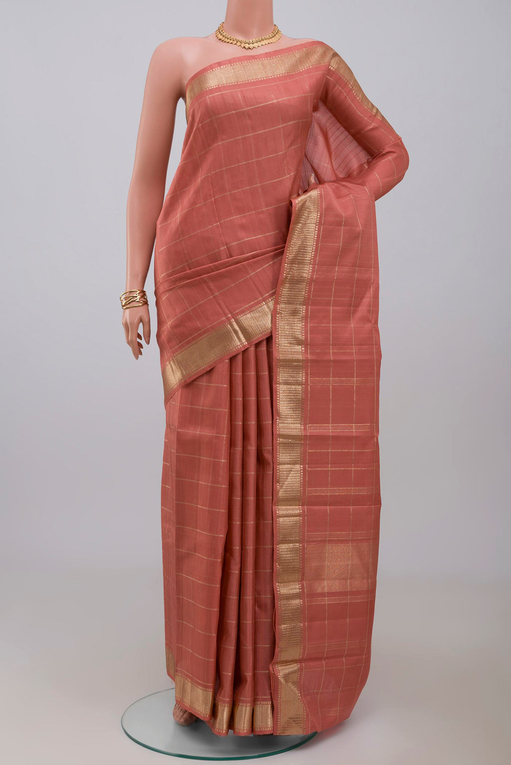 Pure Silk Pure Zari Peach Kanchipuram Saree with Checked design on the body and Zari Border.  displayed on a mannequin