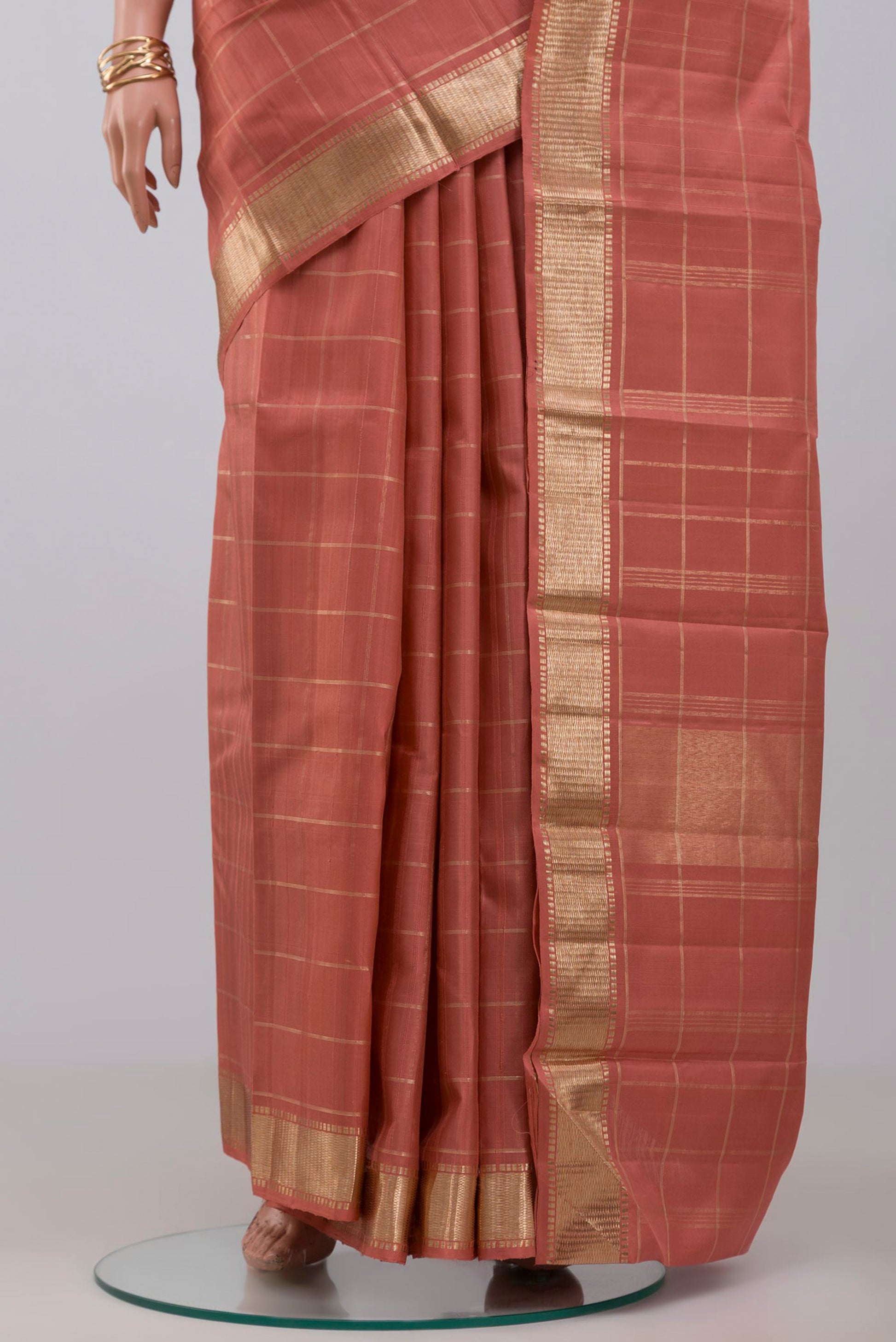 Pleats and pallu of Pure Silk Pure Zari Peach Kanchipuram Saree with Checked design on the body and Zari Border. 