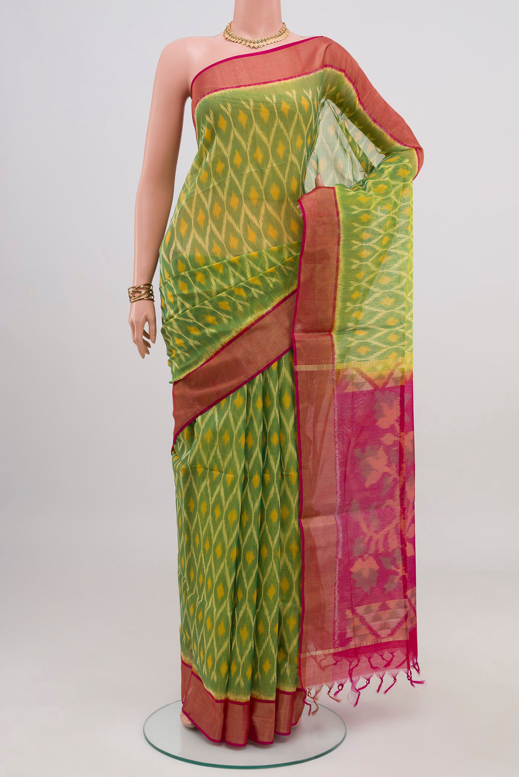 Light Green Silk Cotton Saree with Ikat design on the body and Zari Border.  displayed on a mannequin