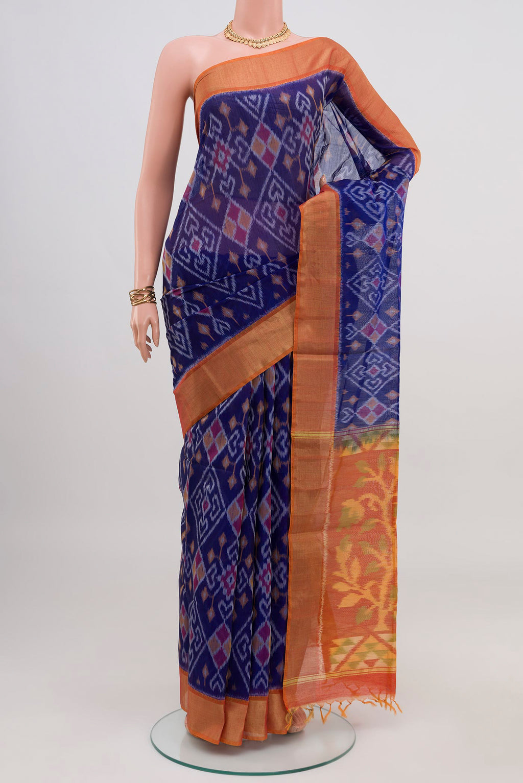 Blue Silk Cotton Saree with Ikat design on the body and Zari Border.  displayed on a mannequin