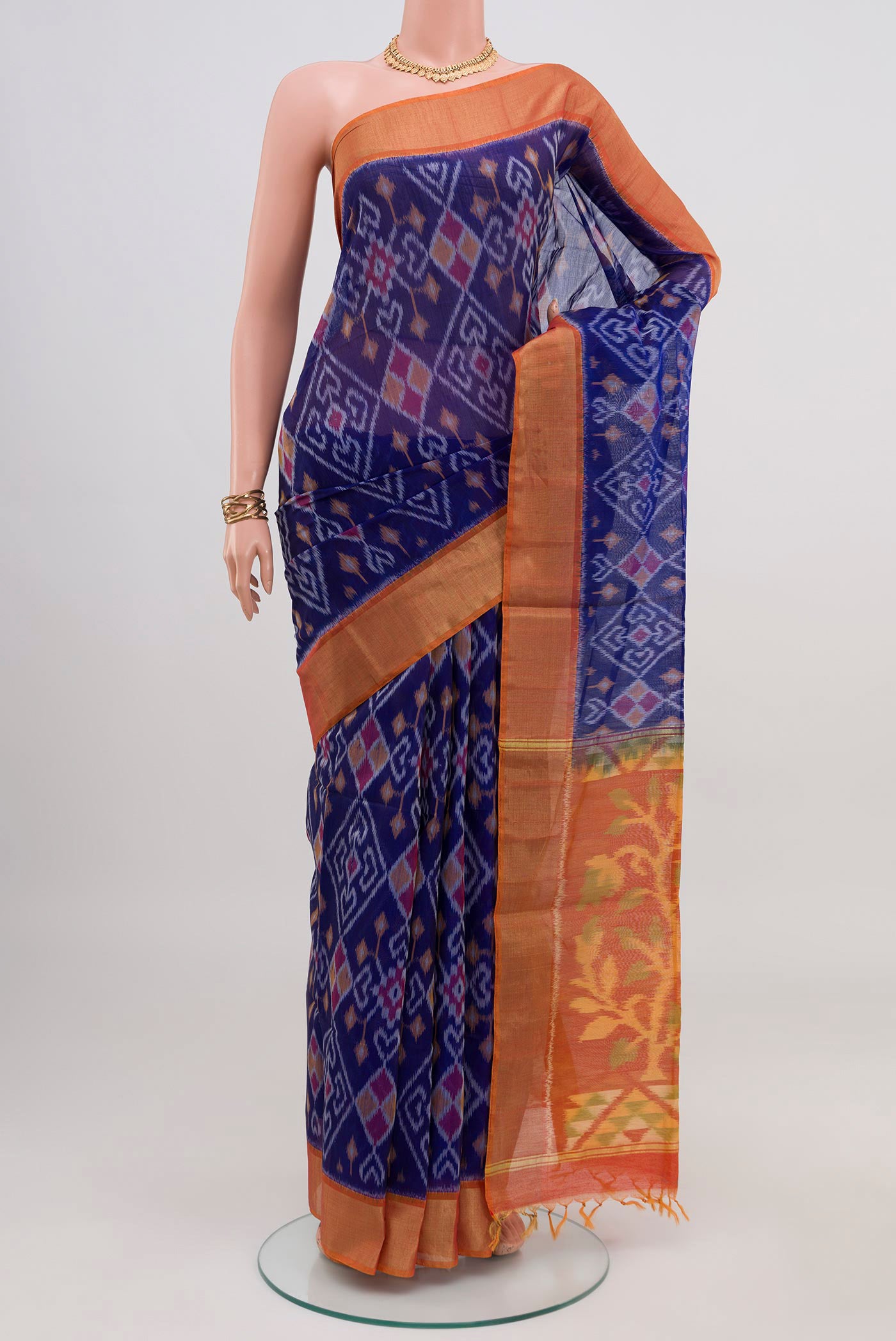 Blue Silk Cotton Saree with Ikat design on the body and Zari Border.  displayed on a mannequin