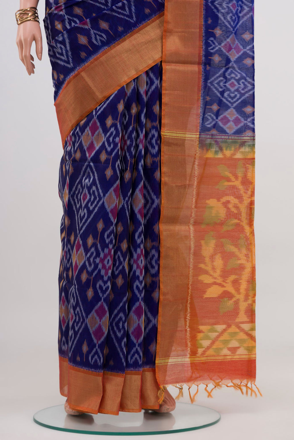 Pleats and pallu of Blue Silk Cotton Saree with Ikat design on the body and Zari Border. 