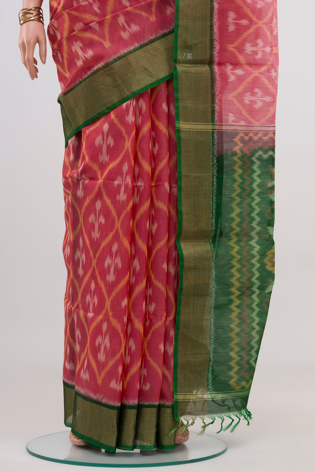 Pleats and pallu of Pink Silk Cotton Saree with Ikat design on the body and Zari Border. 