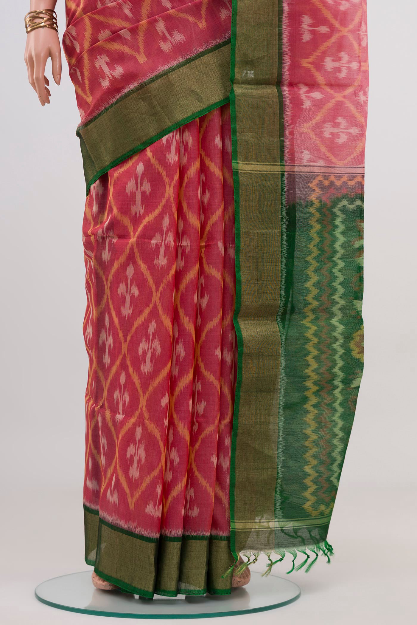 Pleats and pallu of Pink Silk Cotton Saree with Ikat design on the body and Zari Border. 