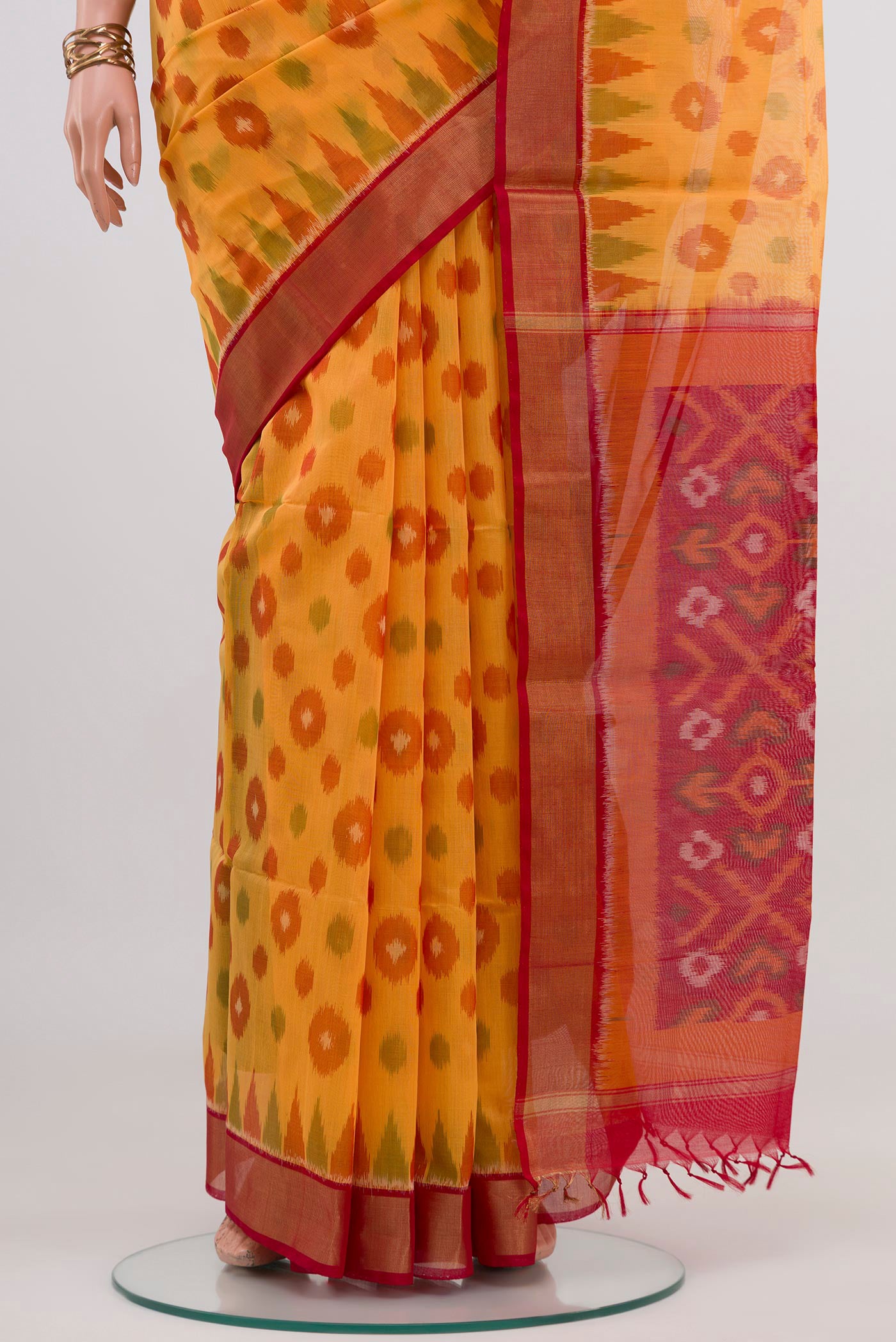 Pleats and pallu of Yellow Silk Cotton Saree with Ikat design on the body and Zari Border. 