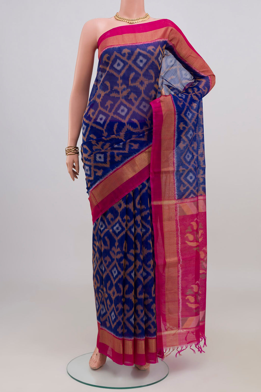 Royal Blue Silk Cotton Saree with Ikat design on the body and Zari Border.  displayed on a mannequin