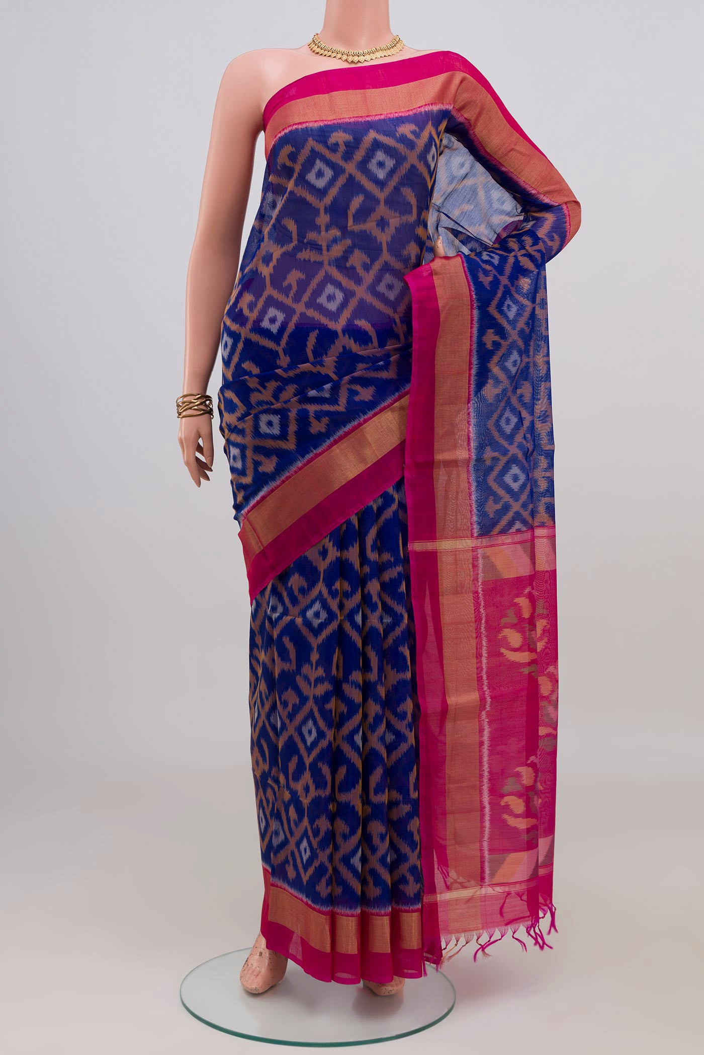 Royal Blue Silk Cotton Saree with Ikat design on the body and Zari Border.  displayed on a mannequin