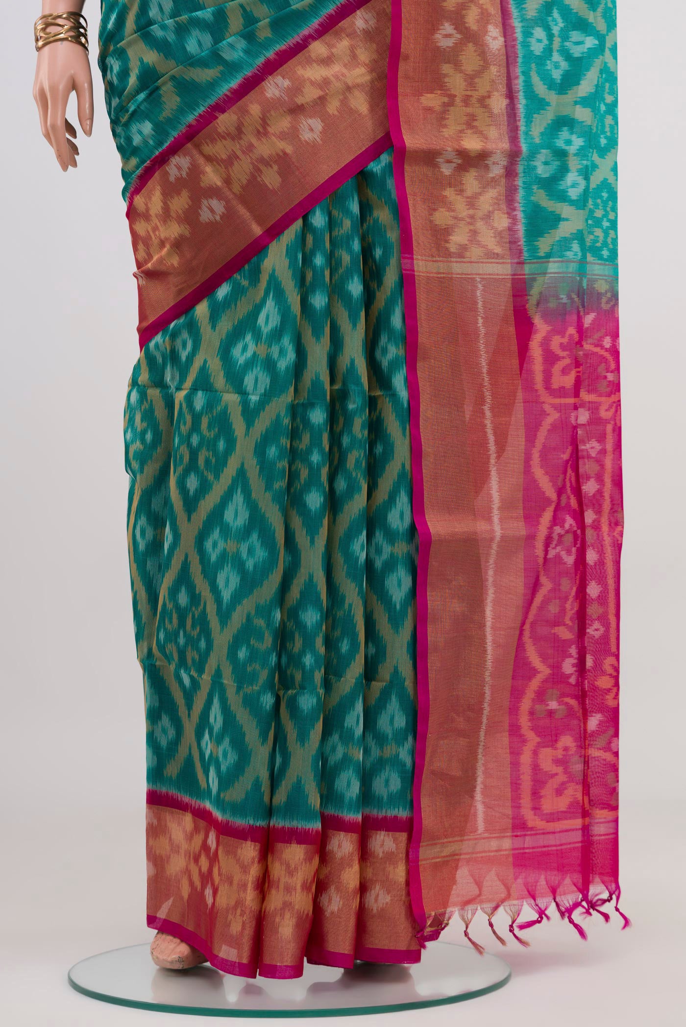Pleats and pallu of Turquoise Silk Cotton Saree with Ikat design on the body and Zari Border. 