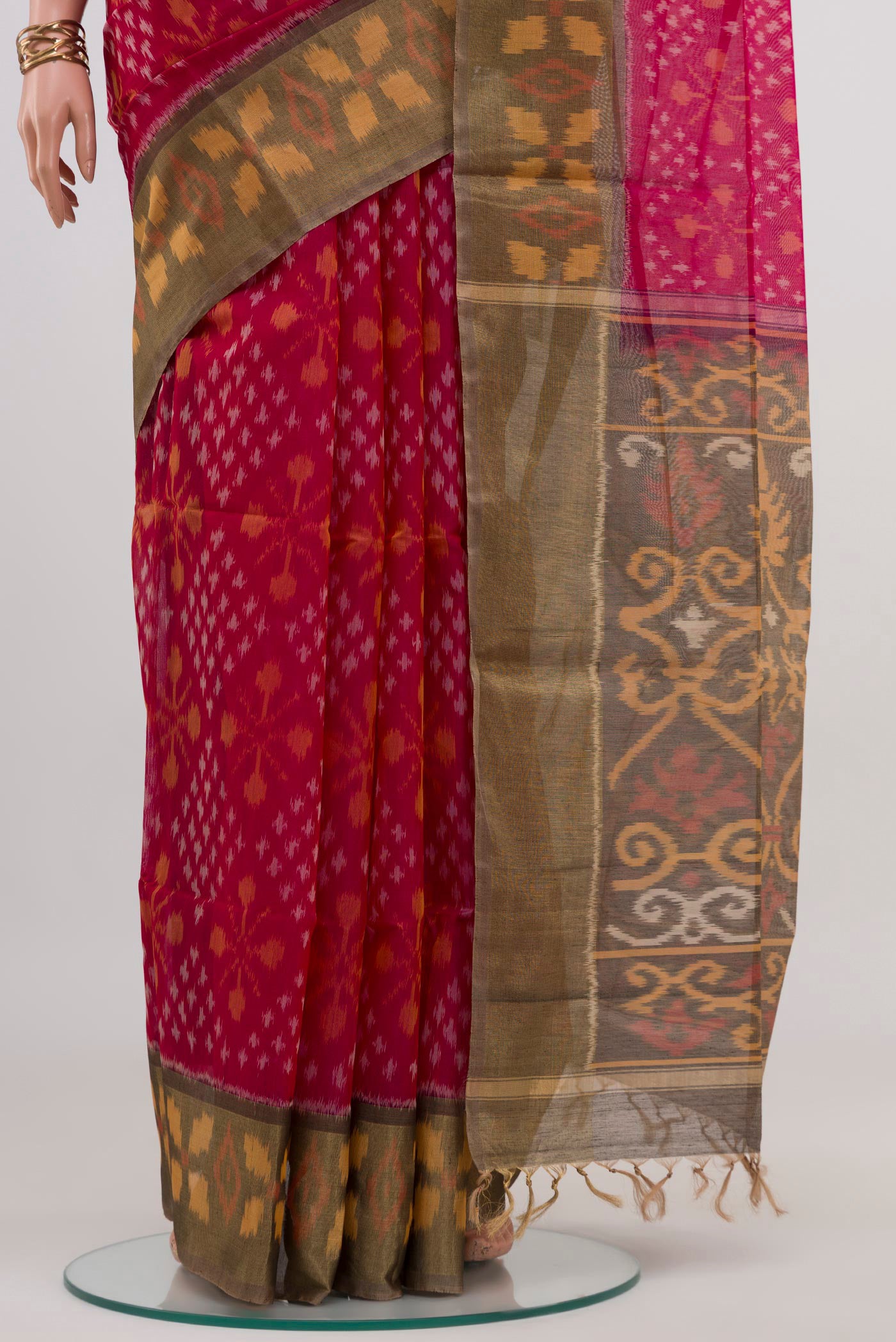 Pleats and pallu of Pink Silk Cotton Saree with Ikat design on the body and Zari Border. 