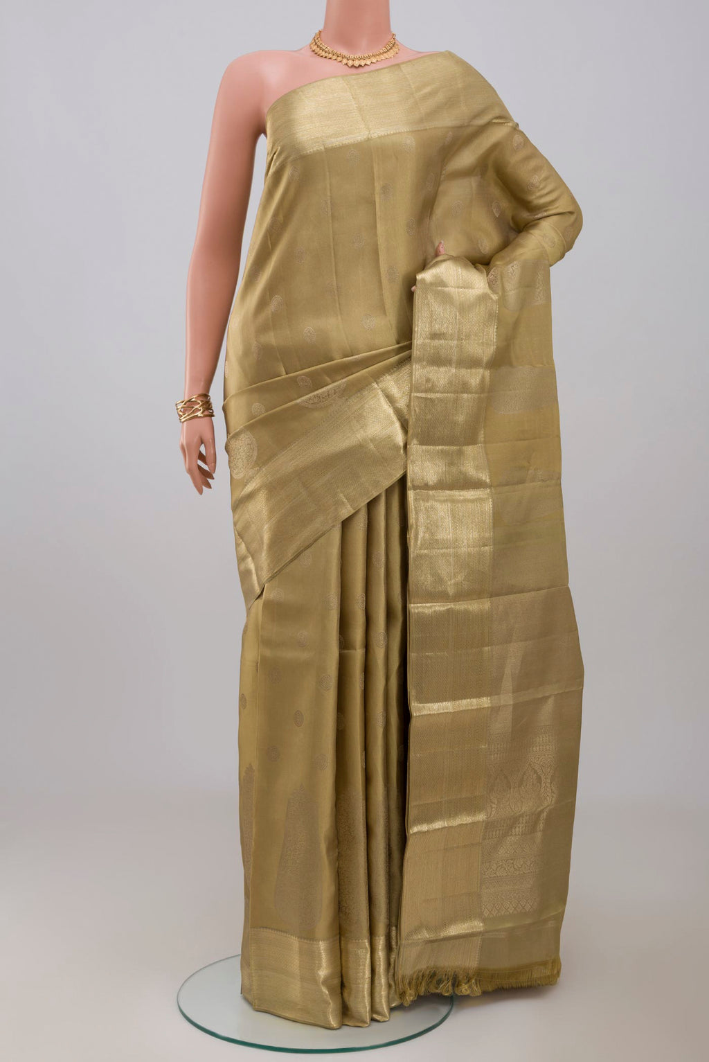 Green Kanjivaram Silk Saree with Zari Brocade on the body and Zari Border.  displayed on a mannequin
