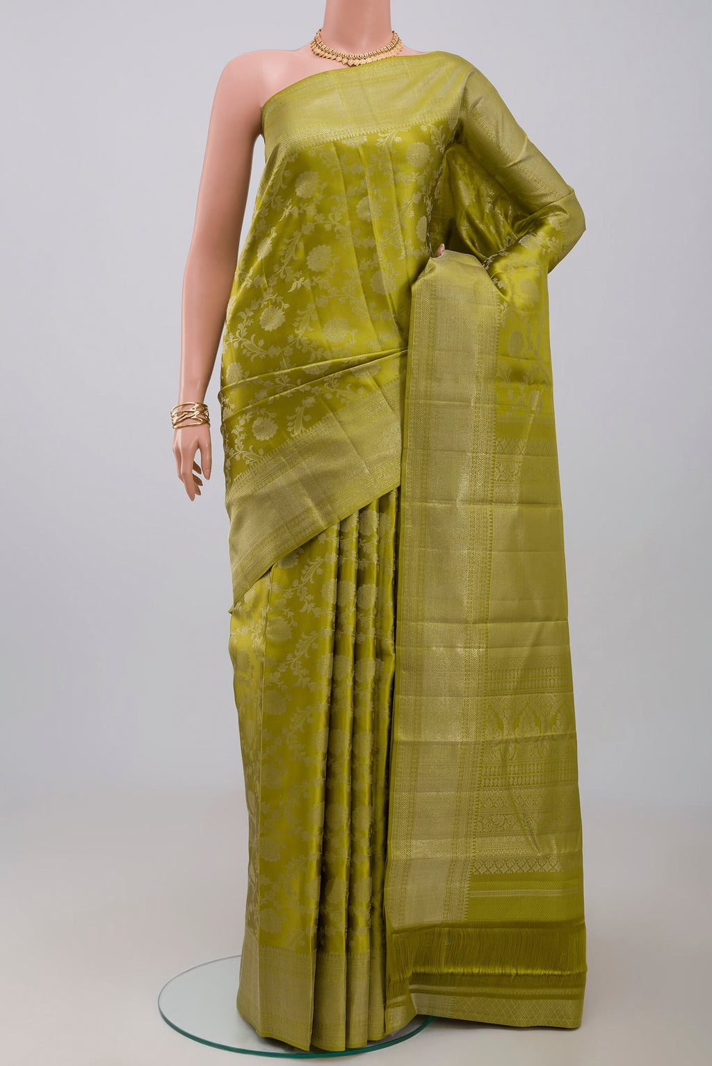 Green Kanjivaram Saree with Zari Brocade on the body and Zari Border.  displayed on a mannequin