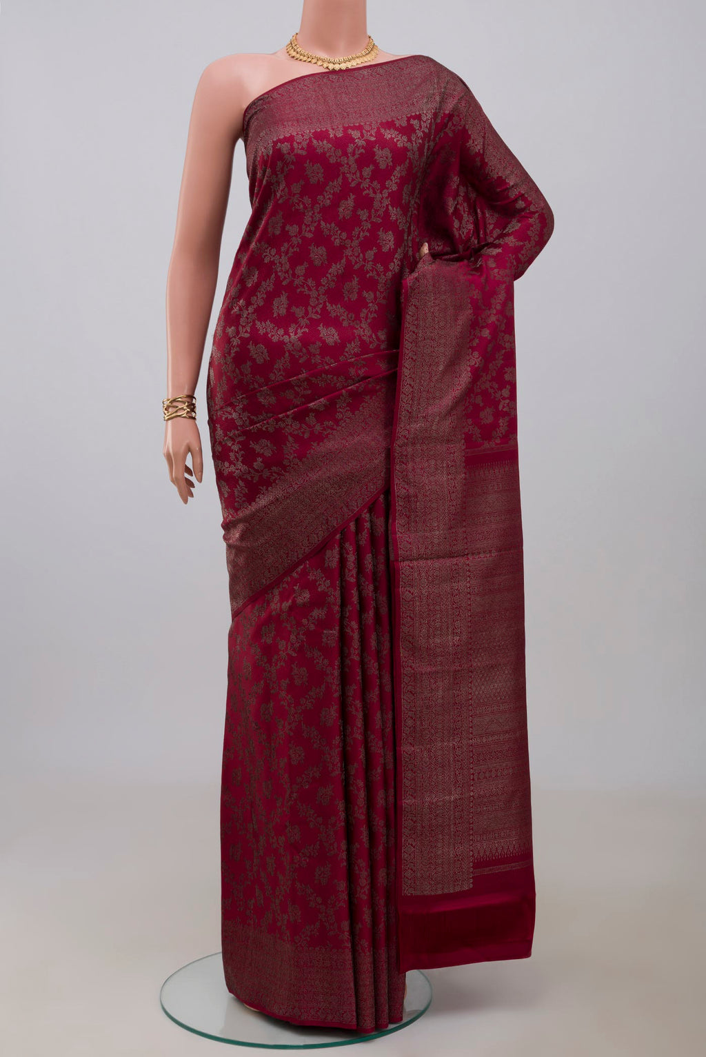 Maroon Kanjivaram Silk Saree with Zari Brocade on the body and Zari Border.  displayed on a mannequin