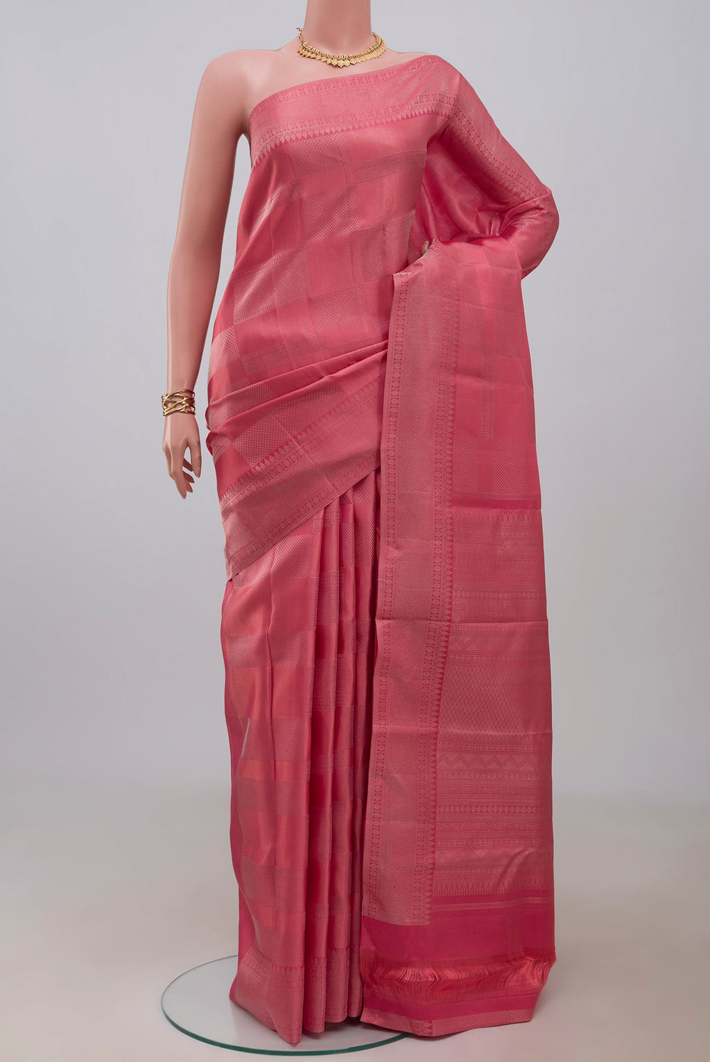 Peach Kanjivaram Silk Saree with Zari Brocade on the body and Zari Border.  displayed on a mannequin