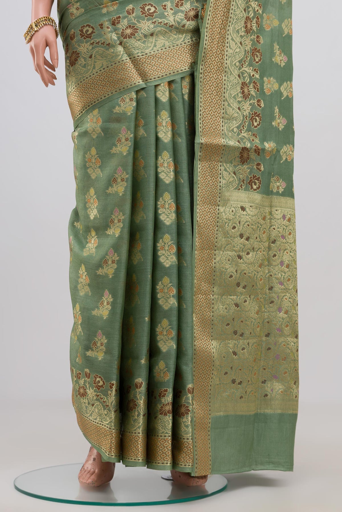 Pleats and pallu of Pista Green Tussar Silk Saree with Zari Butta on the body and Zari Border. 
