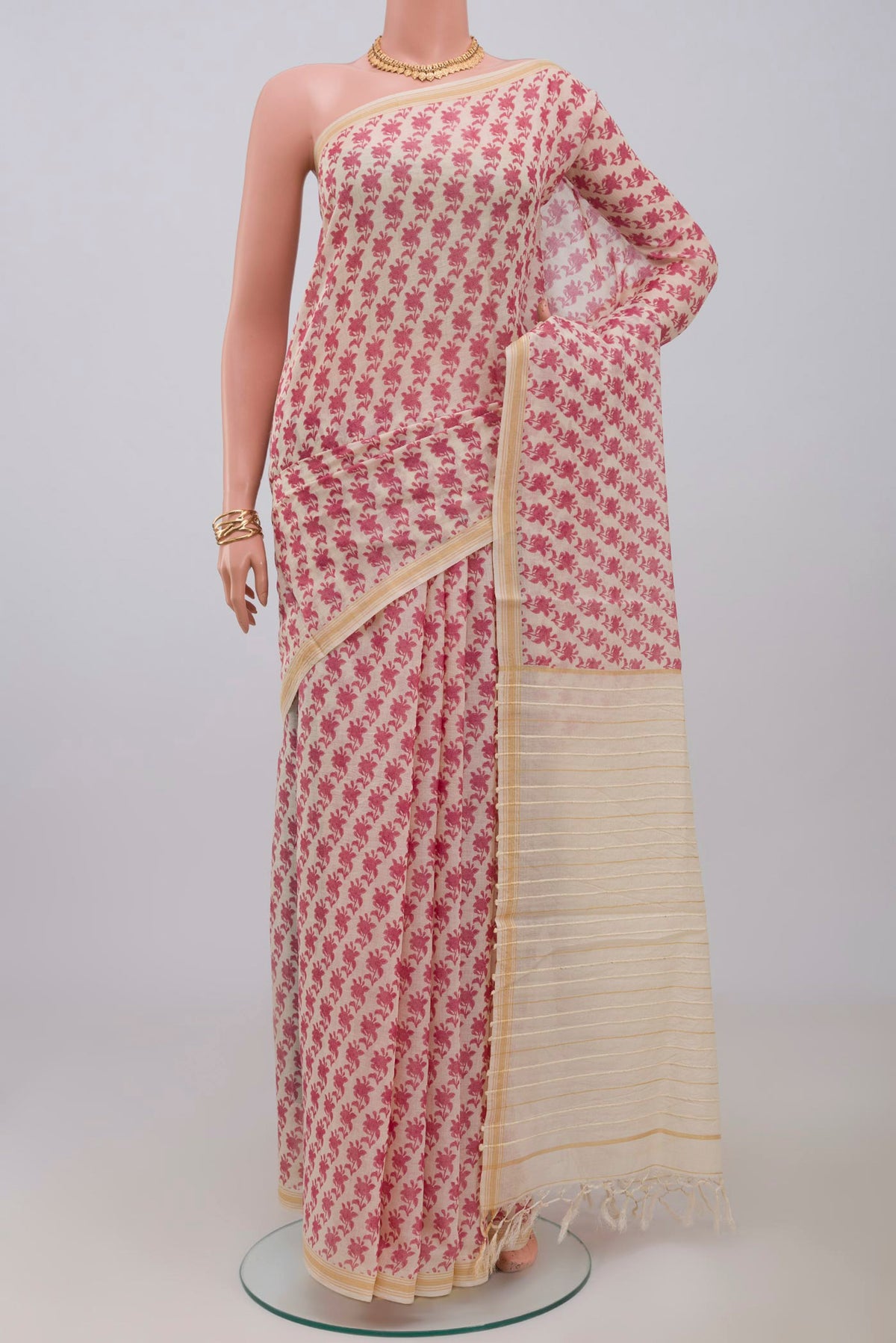 Cream Tussar Saree with Printed design on the body and Thin Zari Line.  displayed on a mannequin