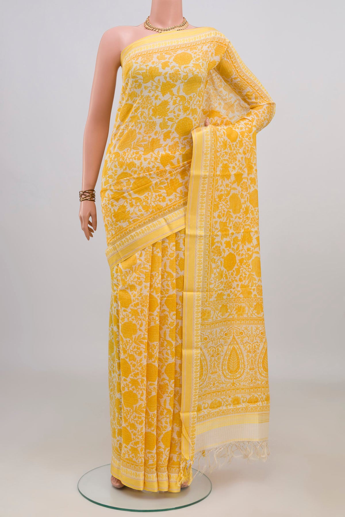 Yellow Tussar Saree with Floral Print on the body and Thread Border.  displayed on a mannequin