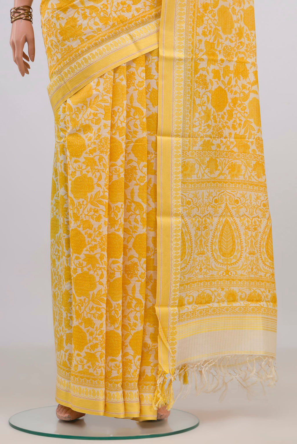 Pleats and pallu of Yellow Tussar Saree with Floral Print on the body and Thread Border. 