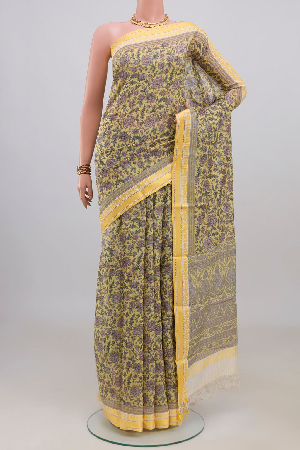 Pure Silk Yellow Tussar Saree with Floral Print on the body and Thread Border.  displayed on a mannequin