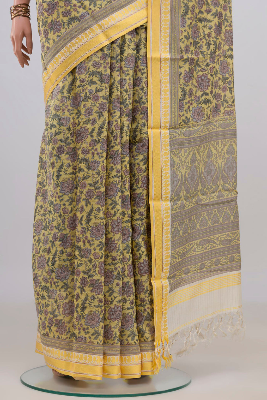 Pleats and pallu of Pure Silk Yellow Tussar Saree with Floral Print on the body and Thread Border. 