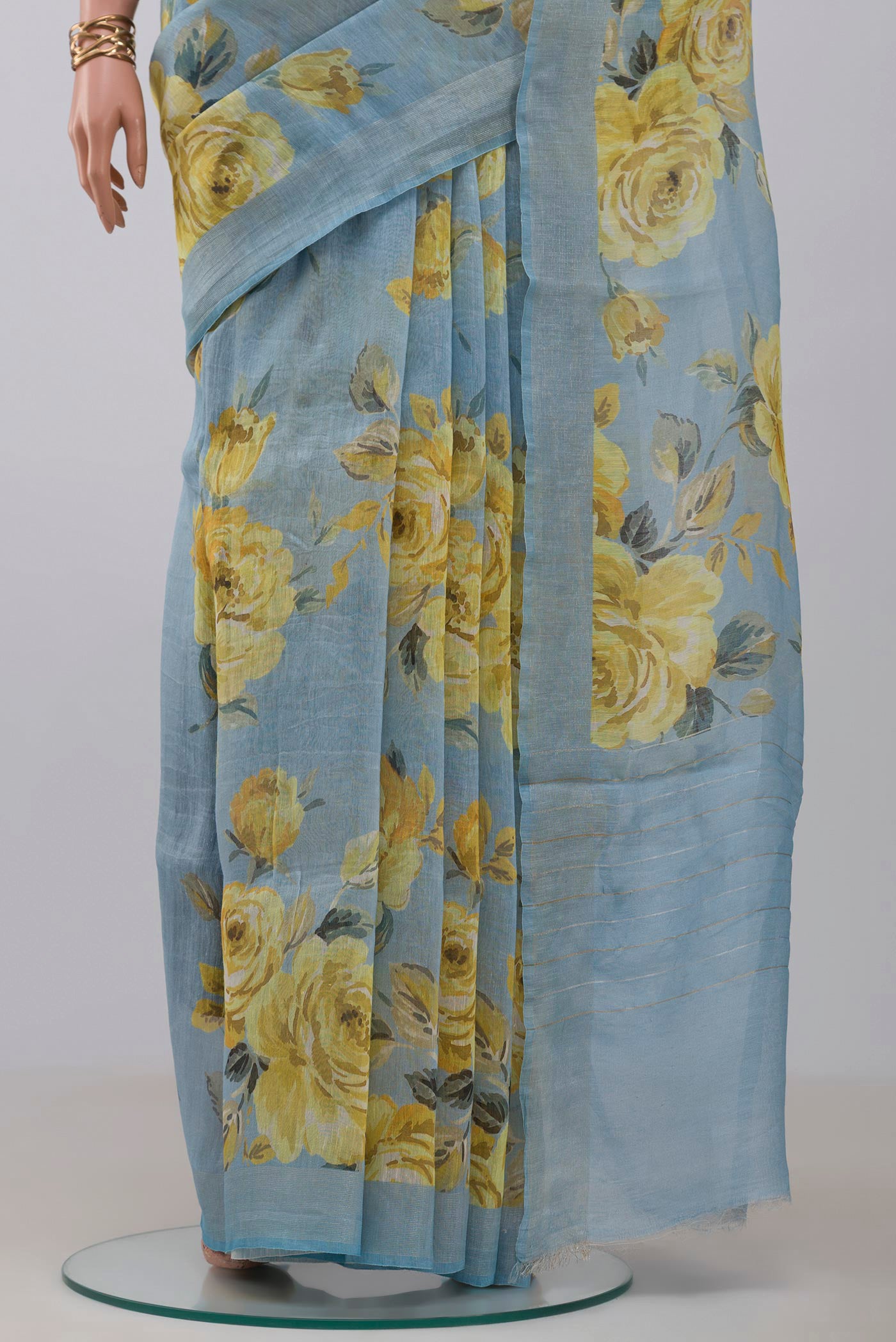 Pleats and pallu of Sky Blue Linen Cotton Saree with Floral Print on the body and Thin Zari Line. 