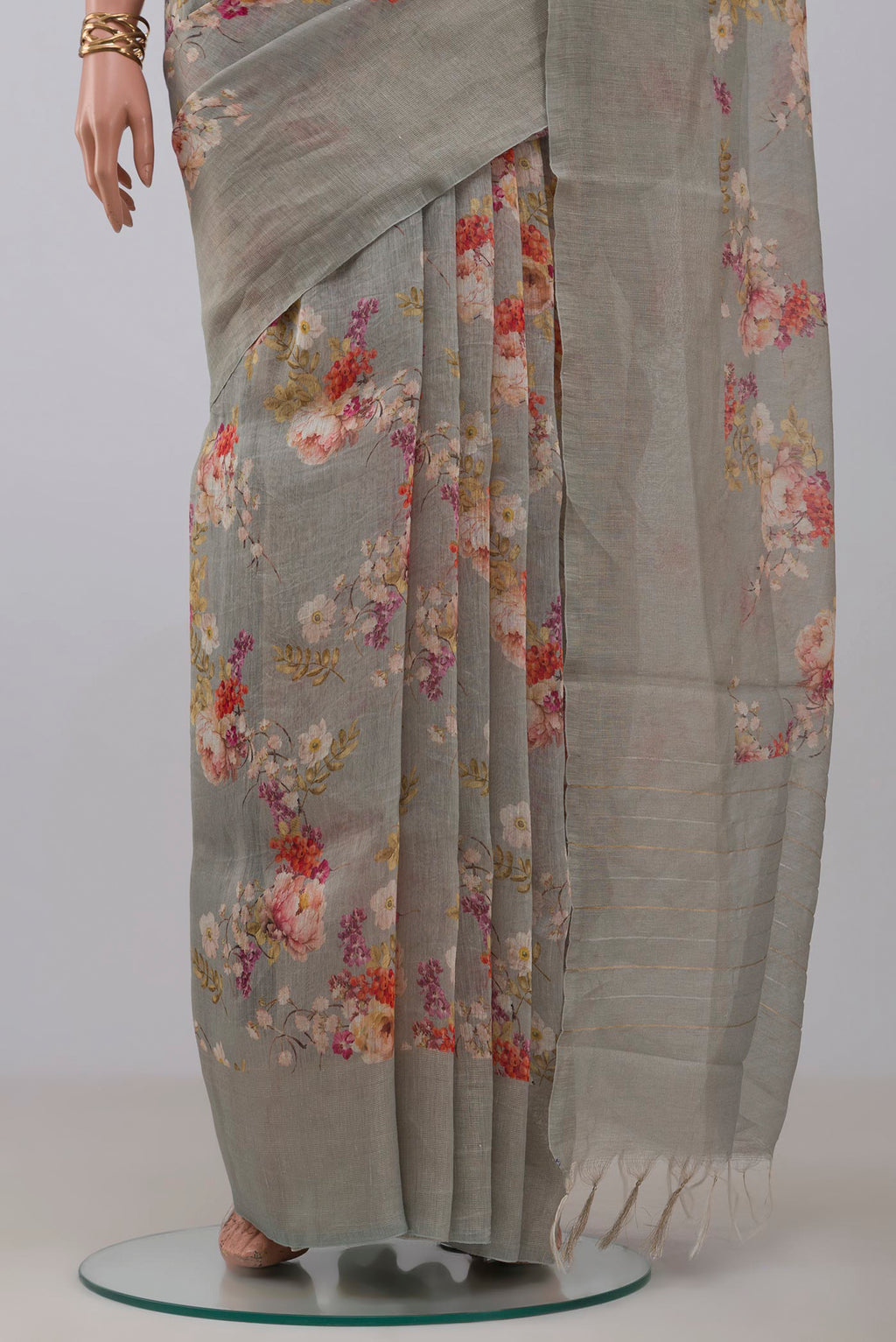 Pleats and pallu of Grey Linen Saree with Floral Print on the body and Thin Zari Line. 