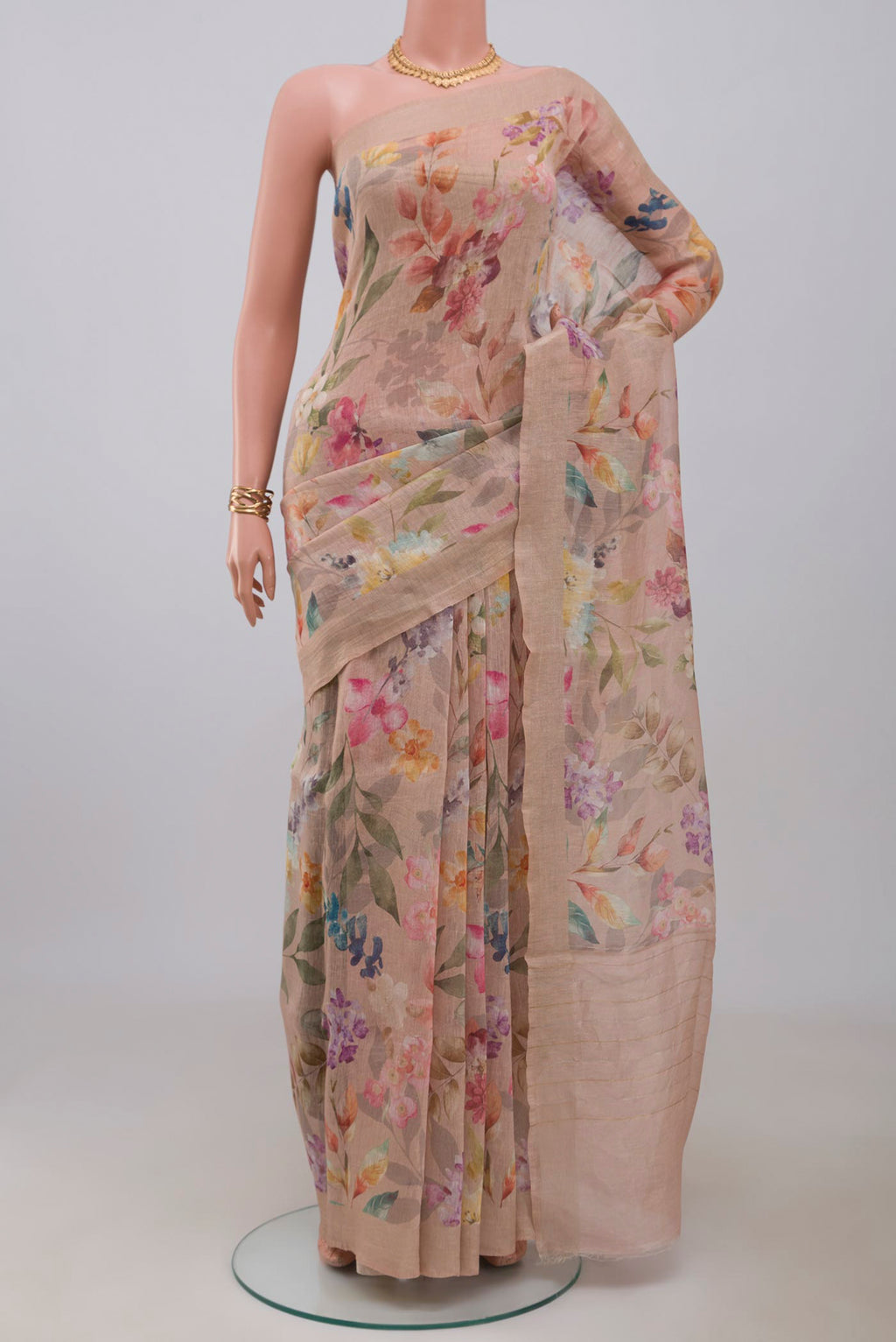 Beige Linen Saree with Floral Print on the body and Thin Zari Line.  displayed on a mannequin