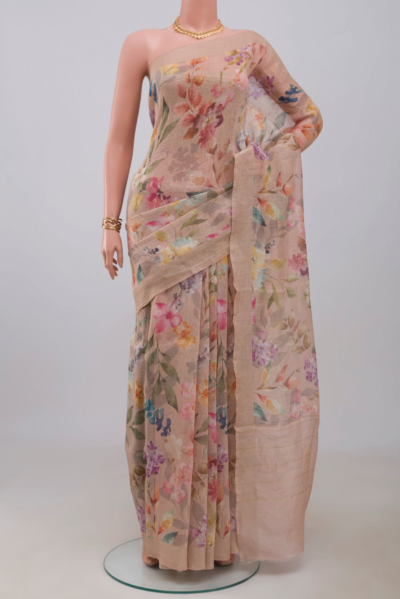Beige Linen Saree with Floral Print on the body and Thin Zari Line.  displayed on a mannequin