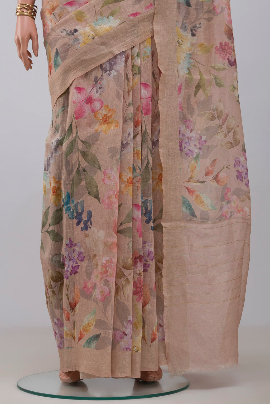Pleats and pallu of Beige Linen Saree with Floral Print on the body and Thin Zari Line. 