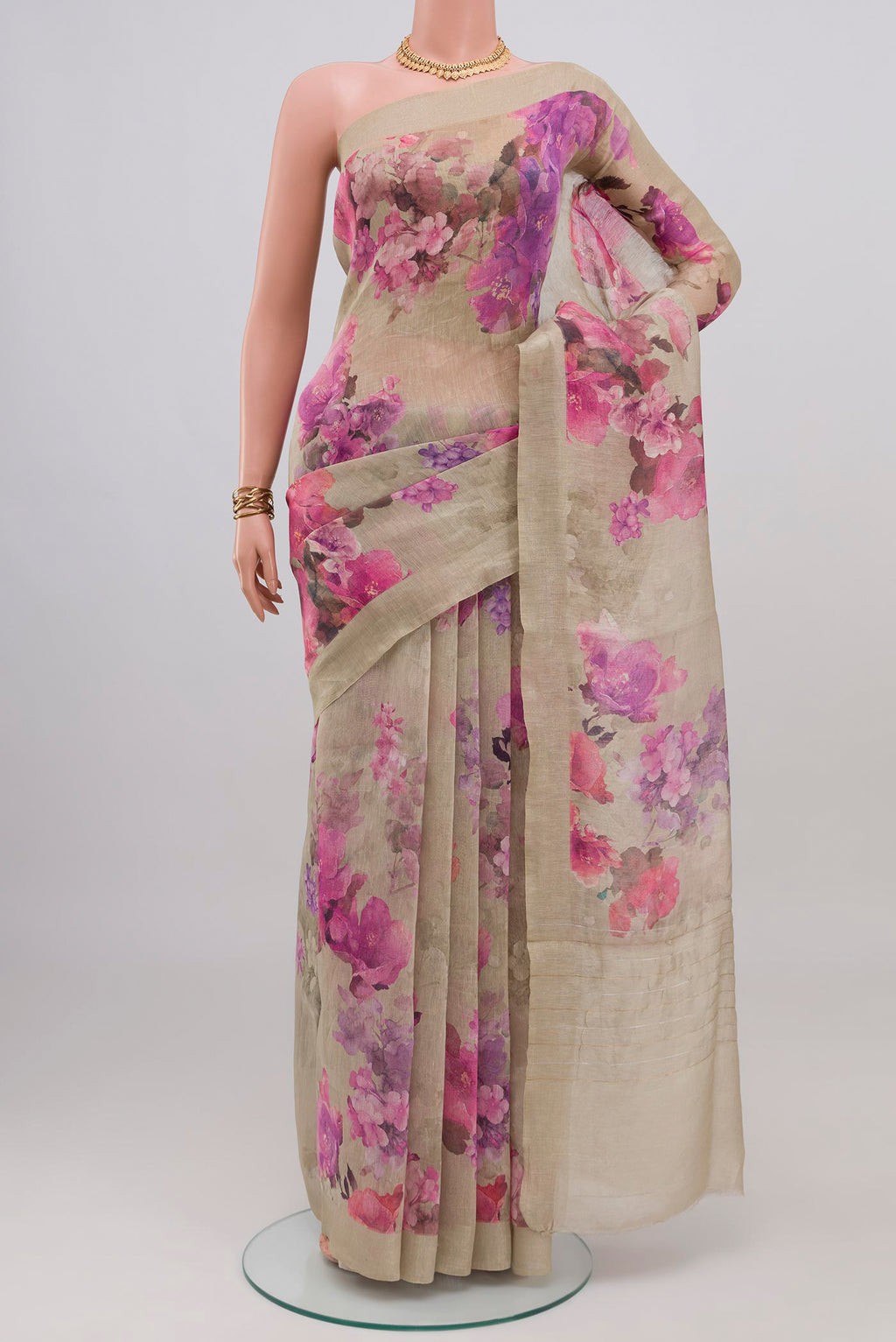 Beige Linen Saree with Floral Print on the body and Thin Zari Line.  displayed on a mannequin