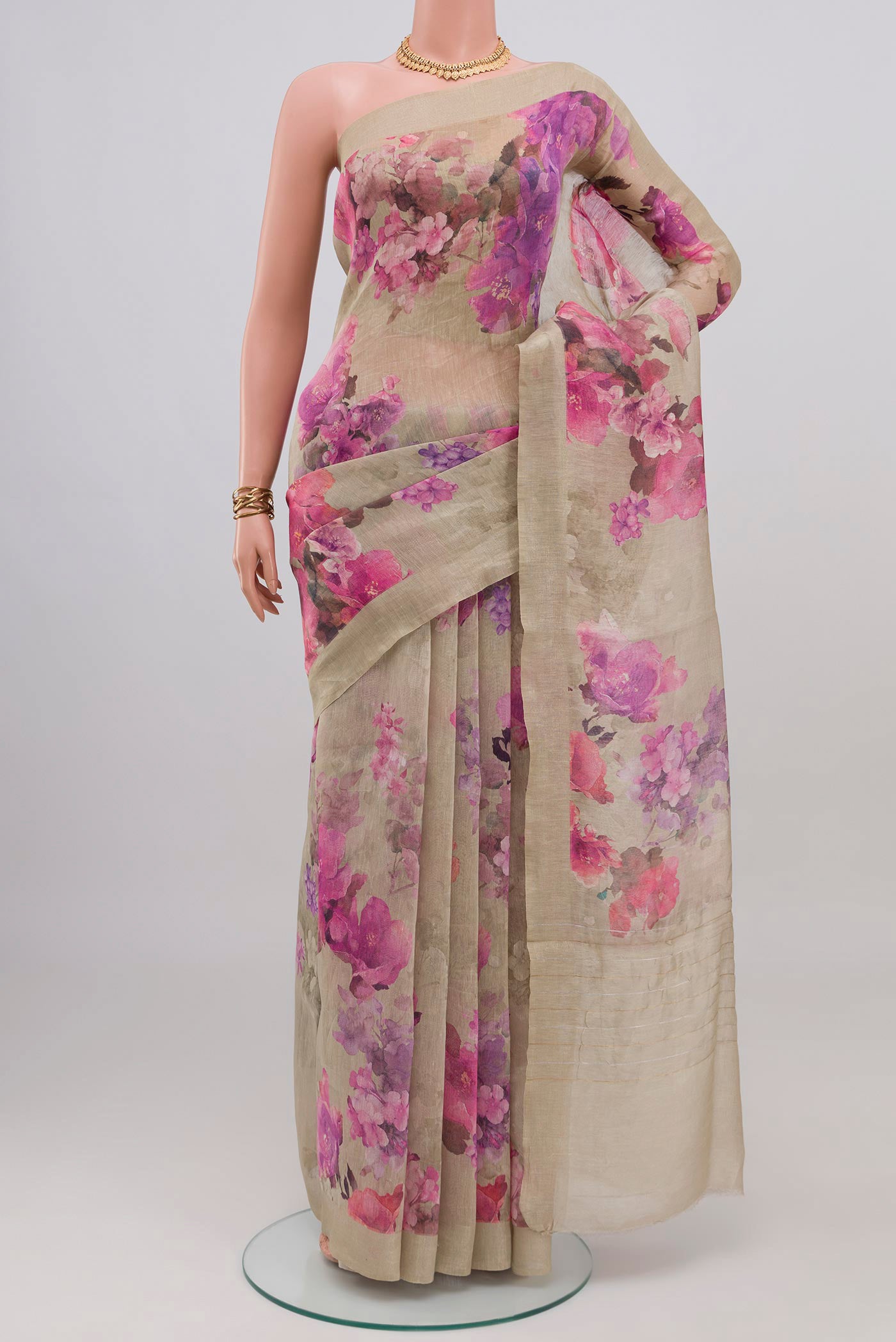 Beige Linen Saree with Floral Print on the body and Thin Zari Line.  displayed on a mannequin