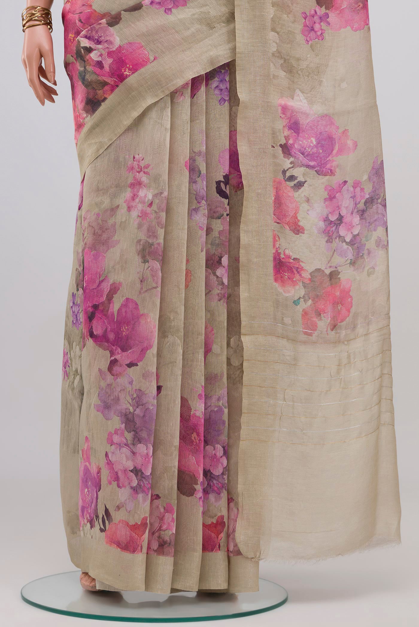 Pleats and pallu of Beige Linen Saree with Floral Print on the body and Thin Zari Line. 