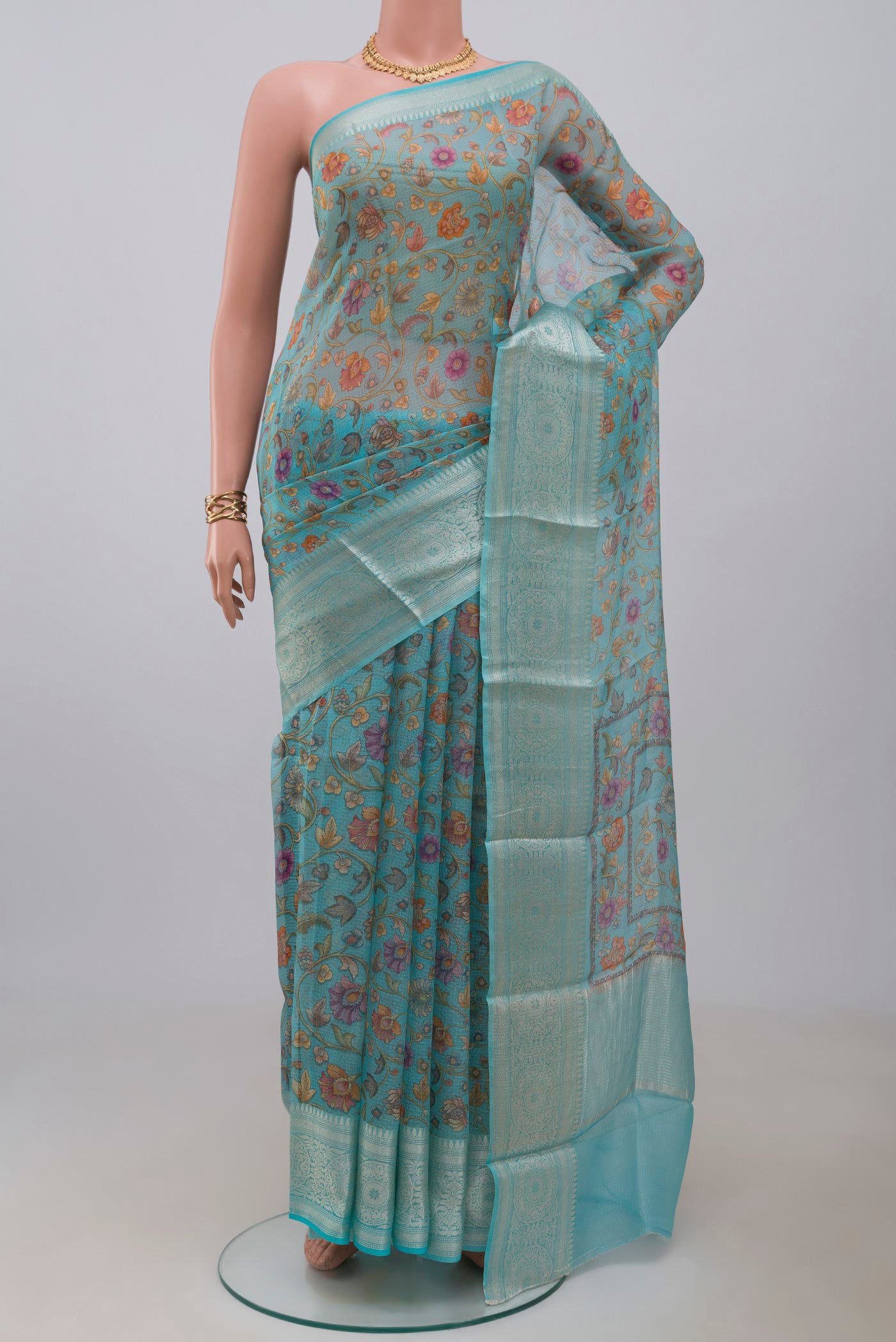 Sky Blue Kota Silk Saree with Printed design on the body and Zari Border.  displayed on a mannequin