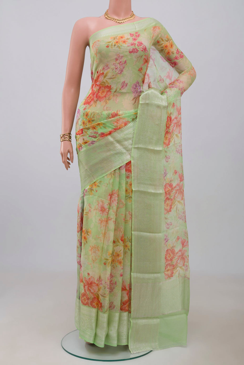 Light Green Kota Silk Saree with Printed design on the body and Zari Border.  displayed on a mannequin