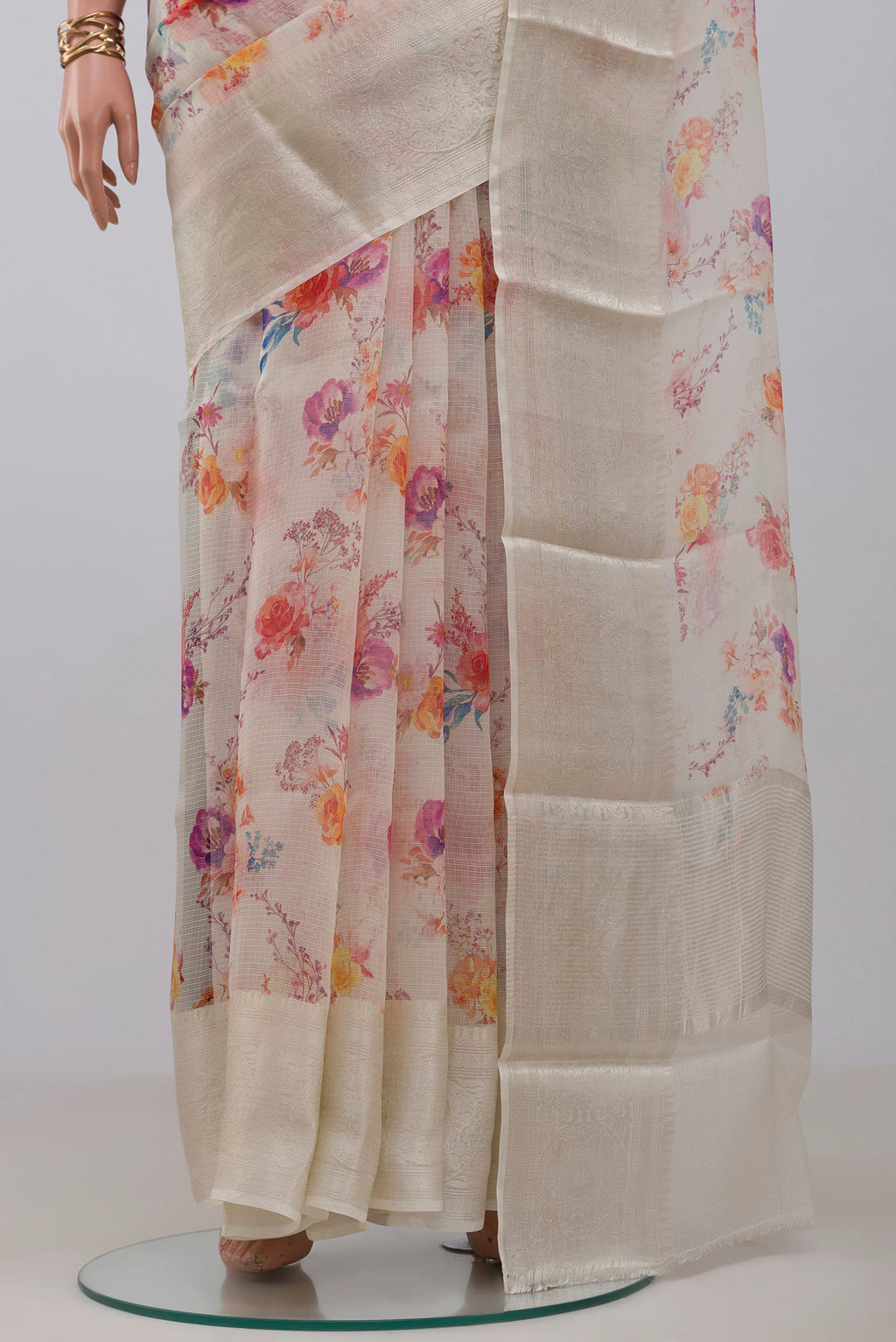 Pleats and pallu of Cream Kota Silk Saree with Floral Print on the body and Zari Border. 