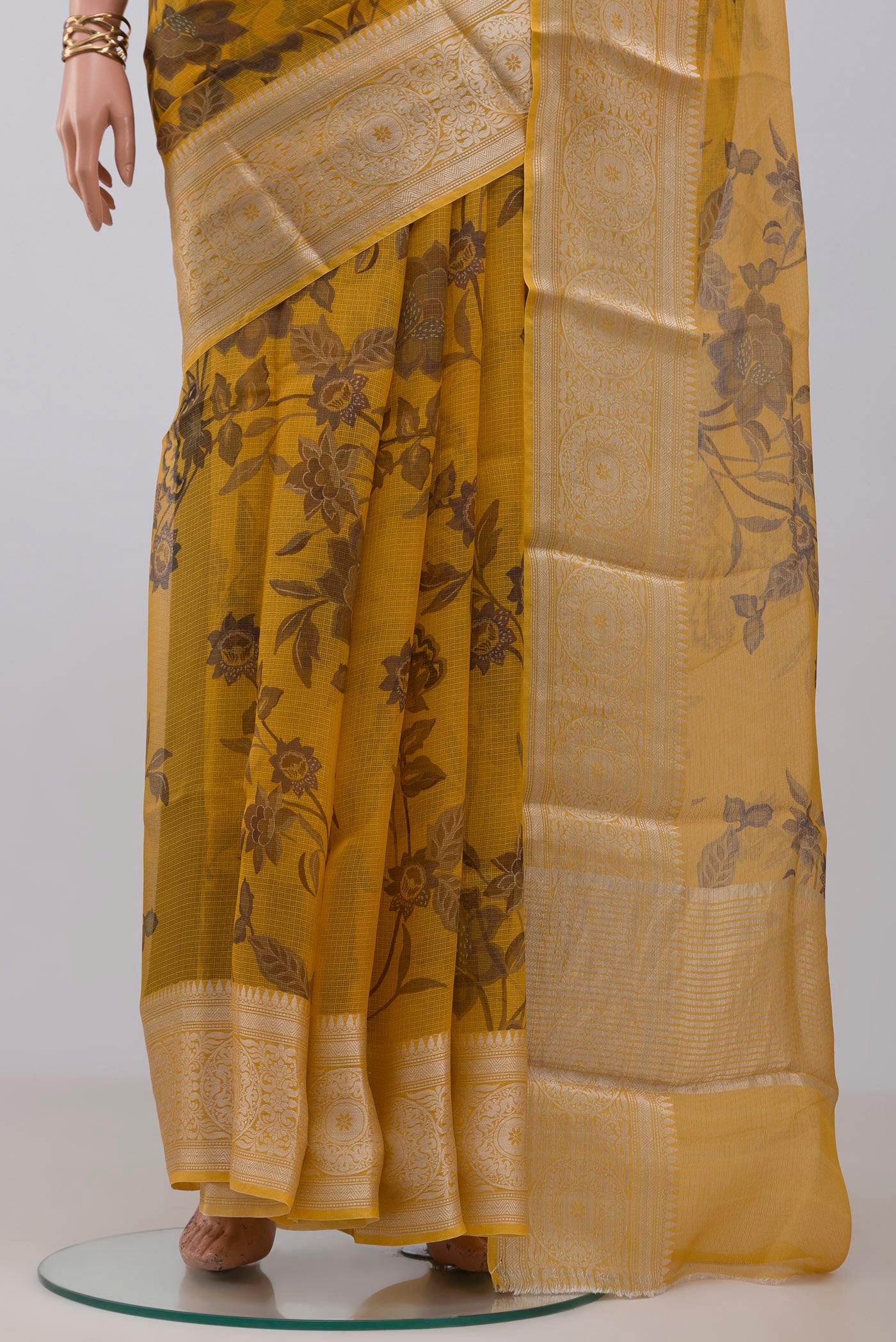 Pleats and pallu of Mustard Kota Silk Saree with Printed design on the body and Zari Border. 