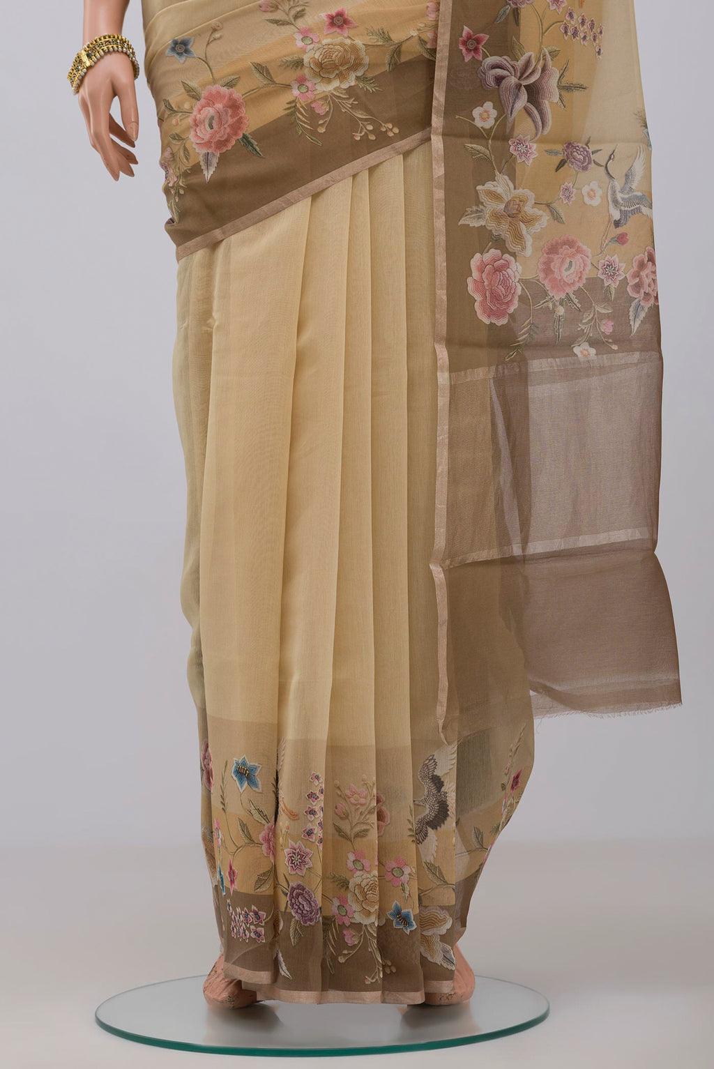 Pleats and pallu of Beige Tussar Saree with Plain Body and Fancy Border. 