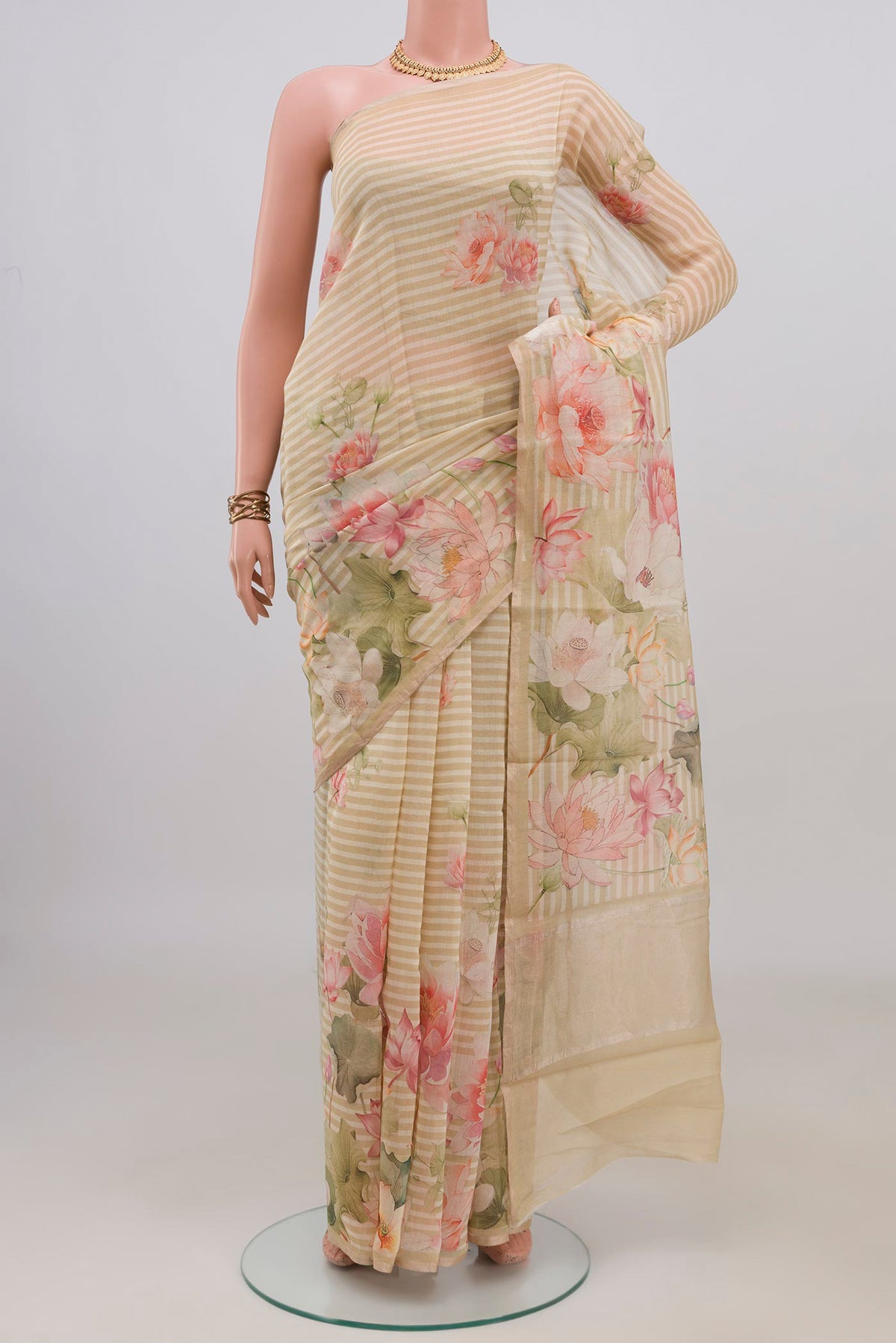 Cream Tussar Saree with Printed design on the body and Thin Zari Line.  displayed on a mannequin