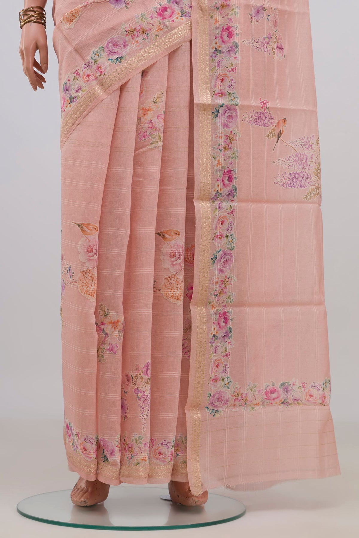 Pleats and pallu of Peach Tussar Saree with Floral Print on the body and Thin Zari Line. 