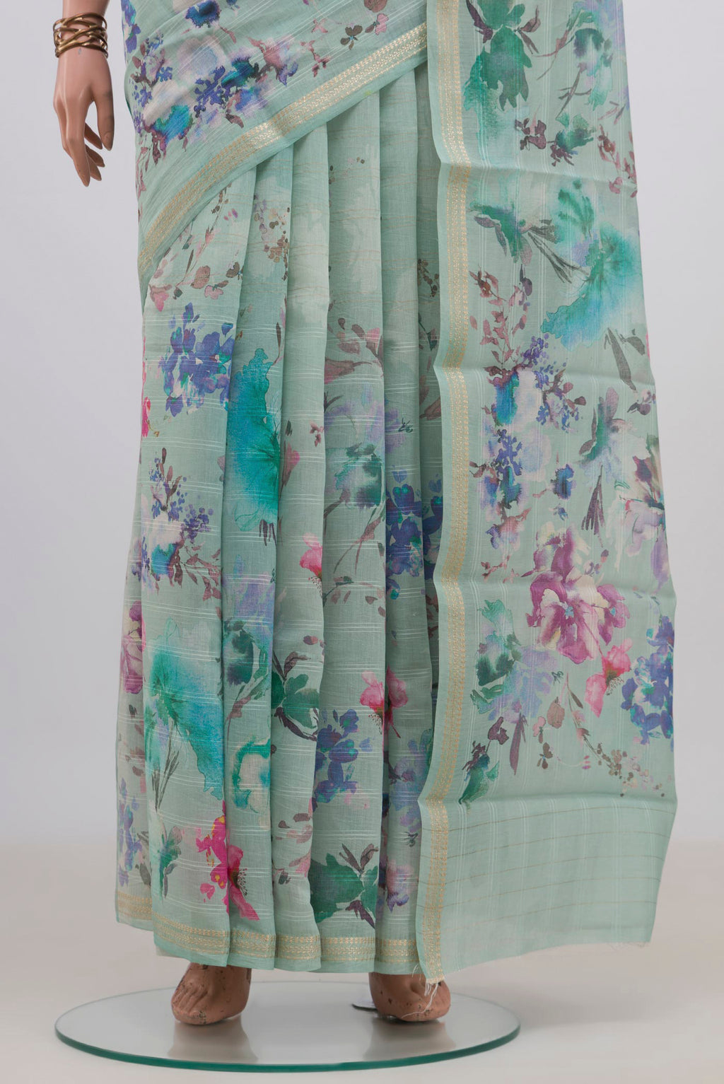 Pleats and pallu of Mint Green Tussar Saree with Floral Print on the body and Thin Zari Line. 