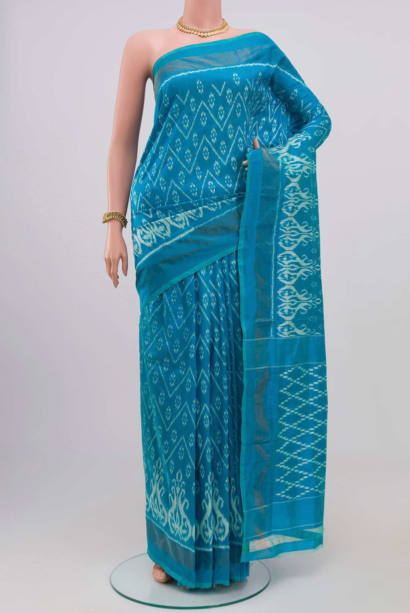 Light Blue Pochampally Silk Saree with Ikat Print on the body and Zari Border.  displayed on a mannequin