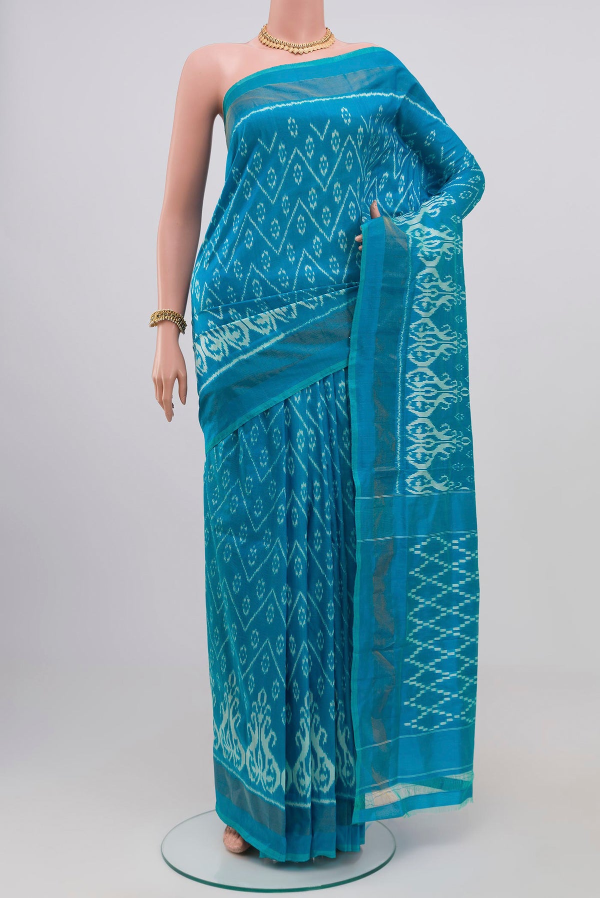 Light Blue Pochampally Silk Saree with Ikat Print on the body and Zari Border.  displayed on a mannequin