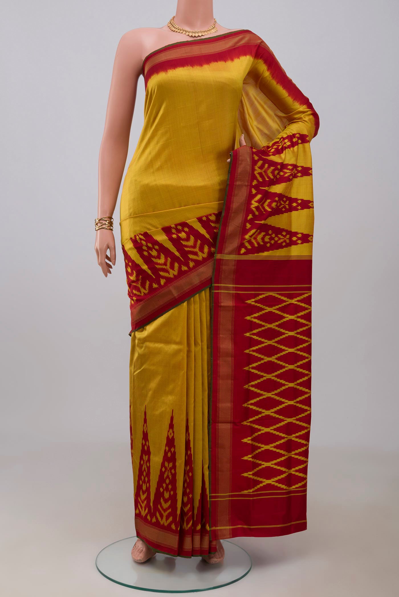 Yellow Pochampally Silk Saree with Plain Body and Ikat Border.  displayed on a mannequin
