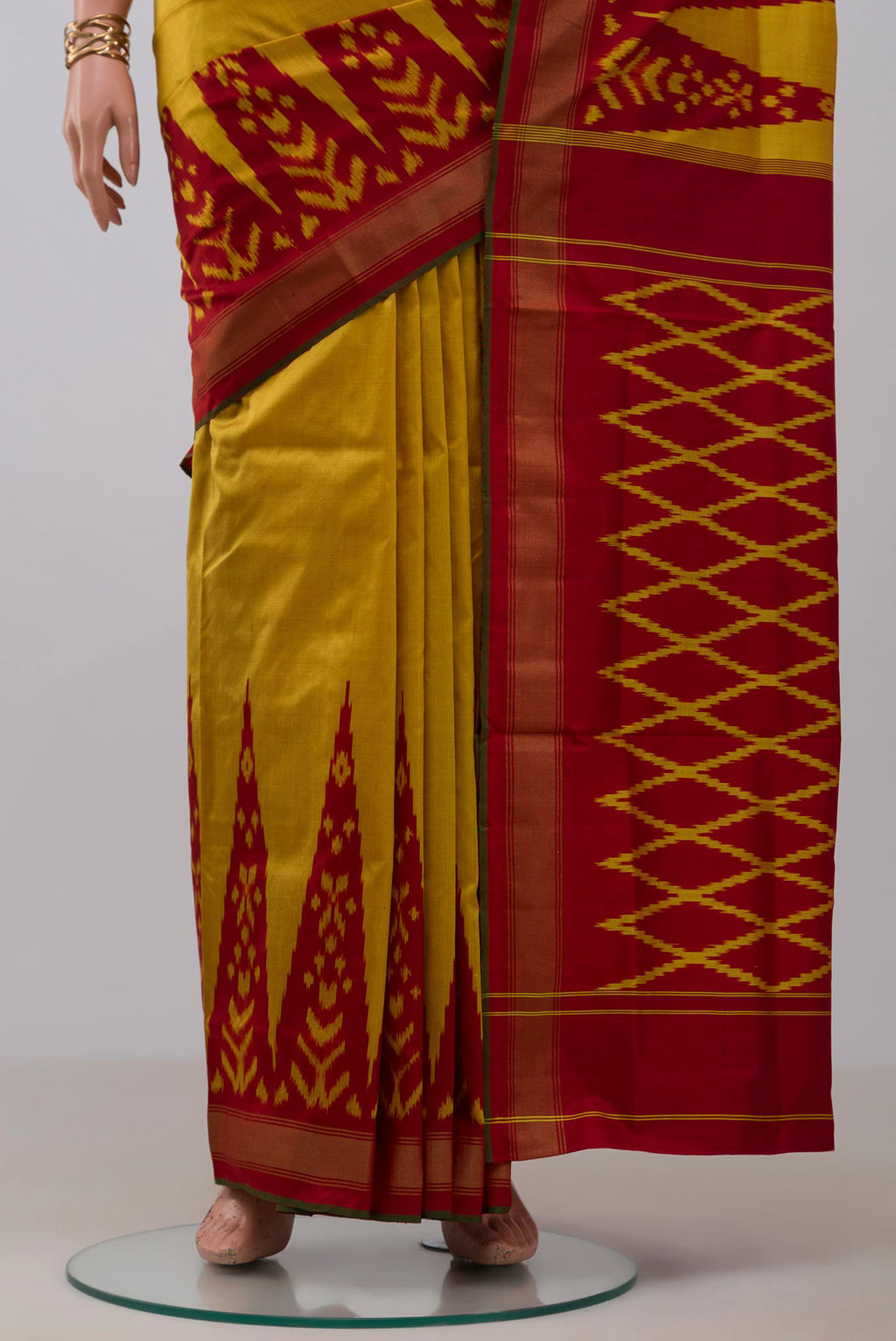 Pleats and pallu of Yellow Pochampally Silk Saree with Plain Body and Ikat Border. 