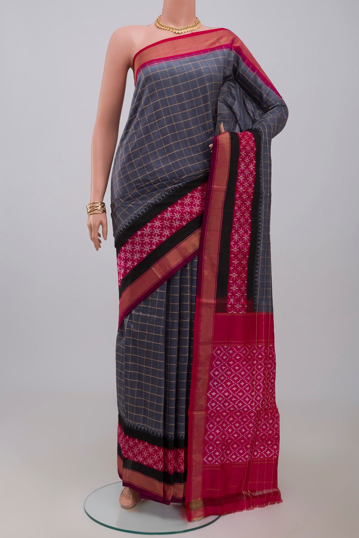 Grey Pochampally Silk Saree with Checked design on the body and Zari Border.  displayed on a mannequin