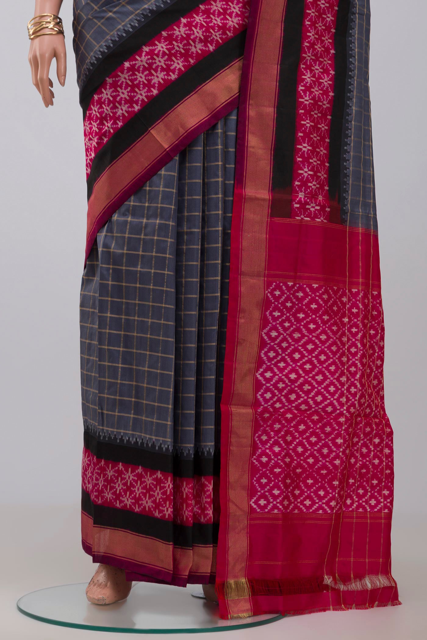 Pleats and pallu of Grey Pochampally Silk Saree with Checked design on the body and Zari Border. 