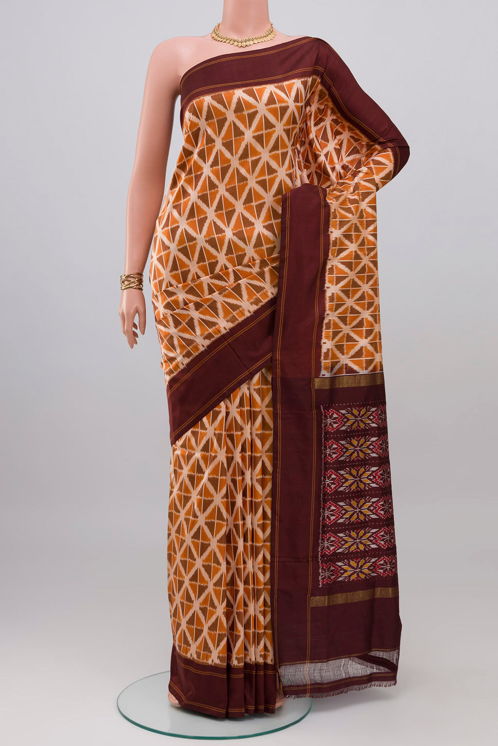 Mustard Pochampally Saree with Ikat design on the body and Plain Border.  displayed on a mannequin