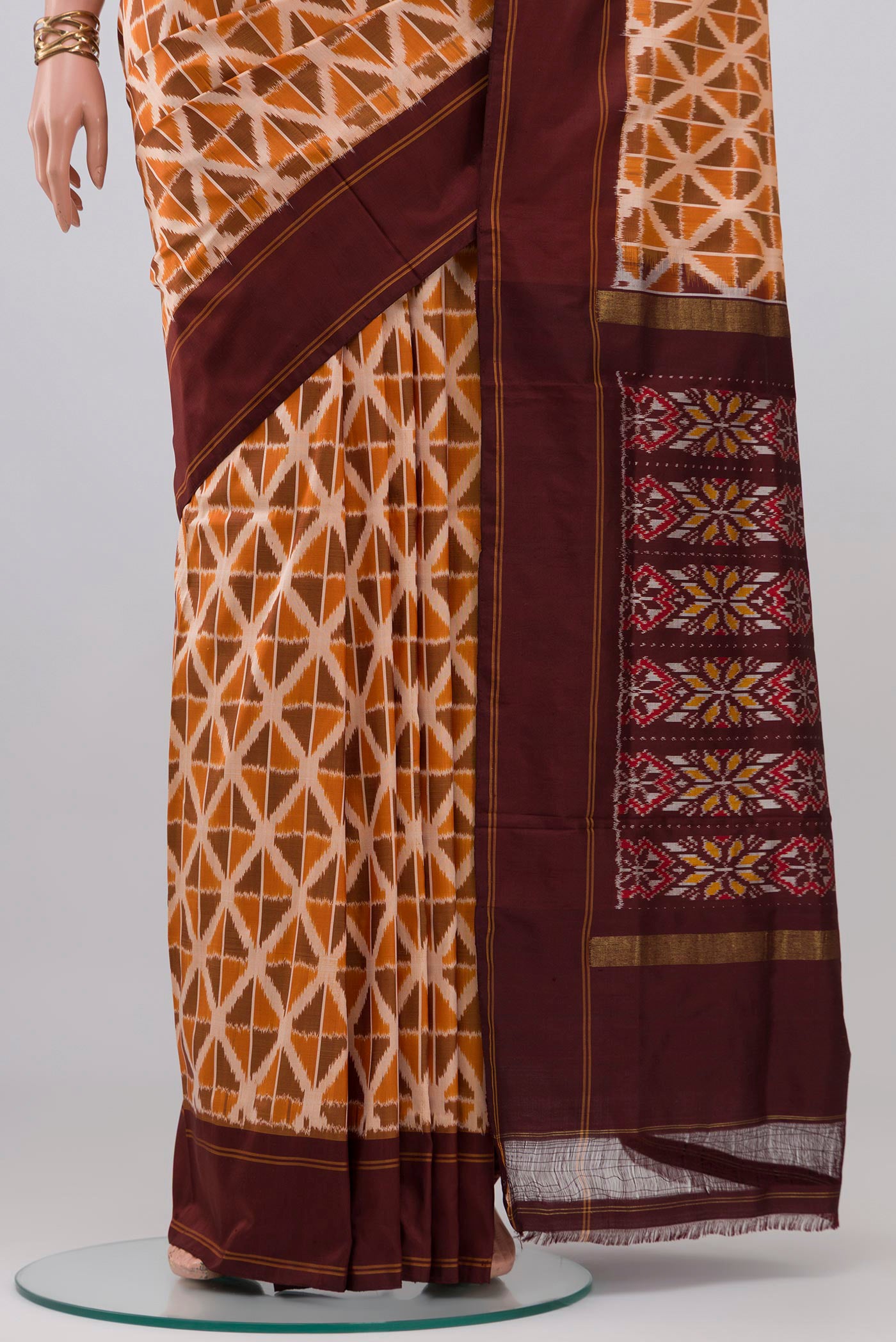 Pleats and pallu of Mustard Pochampally Saree with Ikat design on the body and Plain Border. 