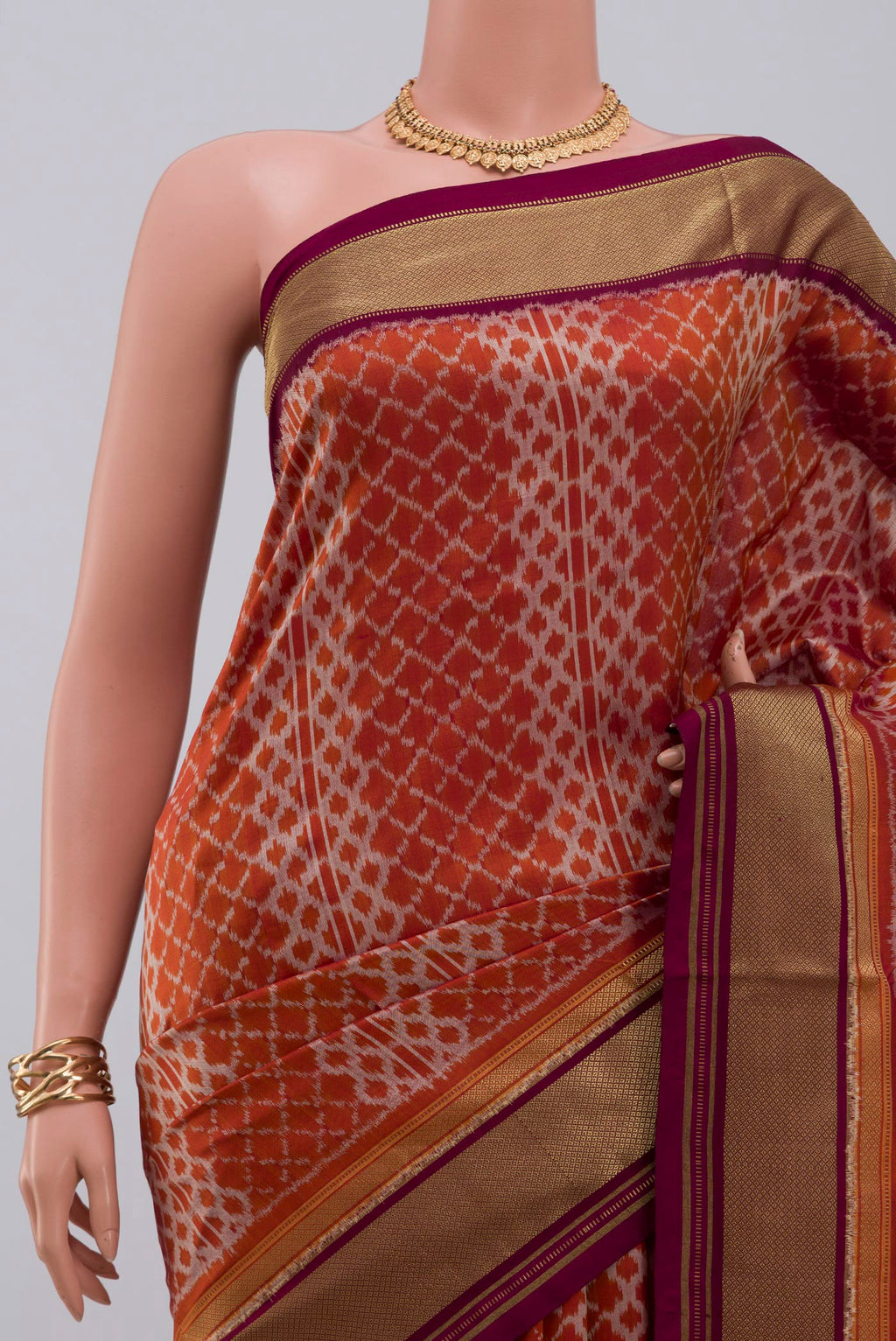 Border image of Rust Pochampally Silk Saree with Ikat design on the body and Zari Border. 