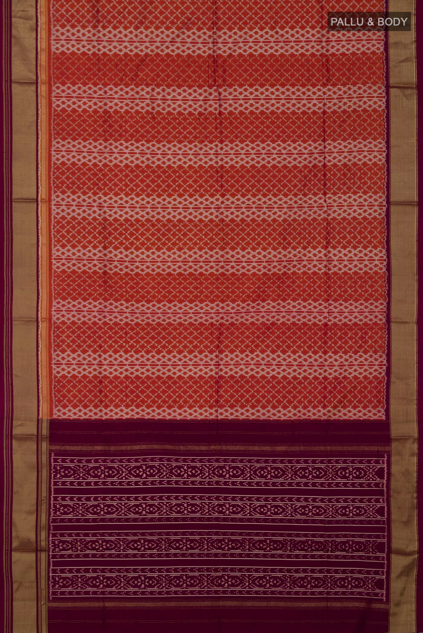Flat view of Rust Pochampally Silk Saree with Ikat design on the body and Zari Border. 